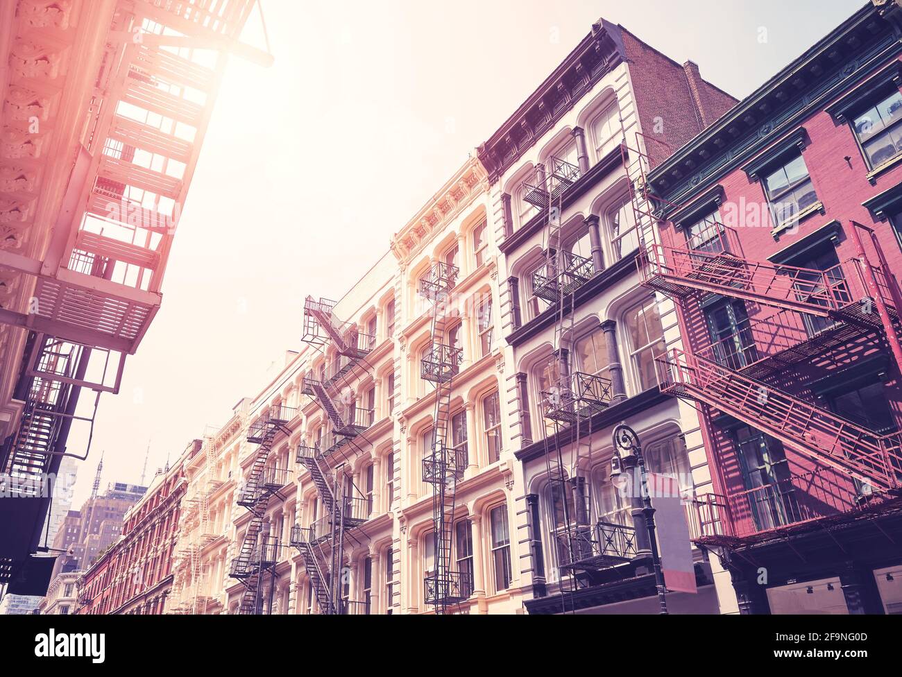 New York cityscape with old buildings with fire escapes, color toning applied, USA. Stock Photo