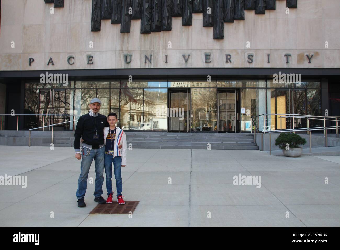 New York, USA. 23rd Mar, 2021. Bardia Gharib (l) stands proudly with his son Shahab Gharib in front of the entrance to Pace University. The 13-year-old, who was born in Bruchsal, Baden-Württemberg, and moved to Florida with his parents as a toddler, has been studying at New York's renowned Pace University since this spring - as one of the youngest students in the history of the educational institution. Credit: Christina Horsten/dpa/Alamy Live News Stock Photo