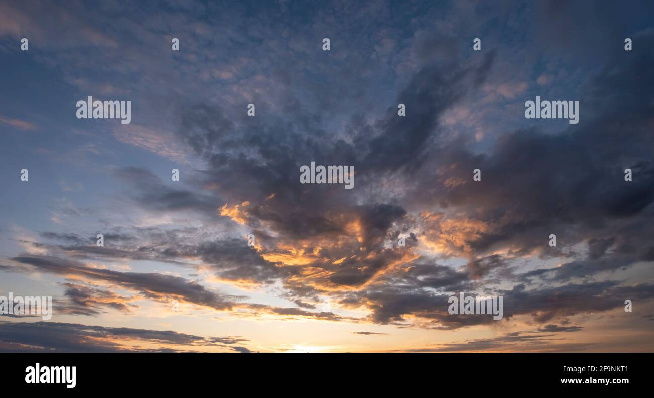 Sunset sky with clouds in blue and orange colors Stock Photo - Alamy