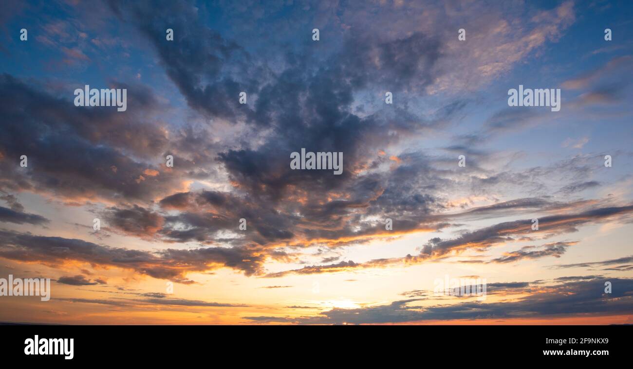 Sunset sky with clouds in blue and orange colors Stock Photo - Alamy