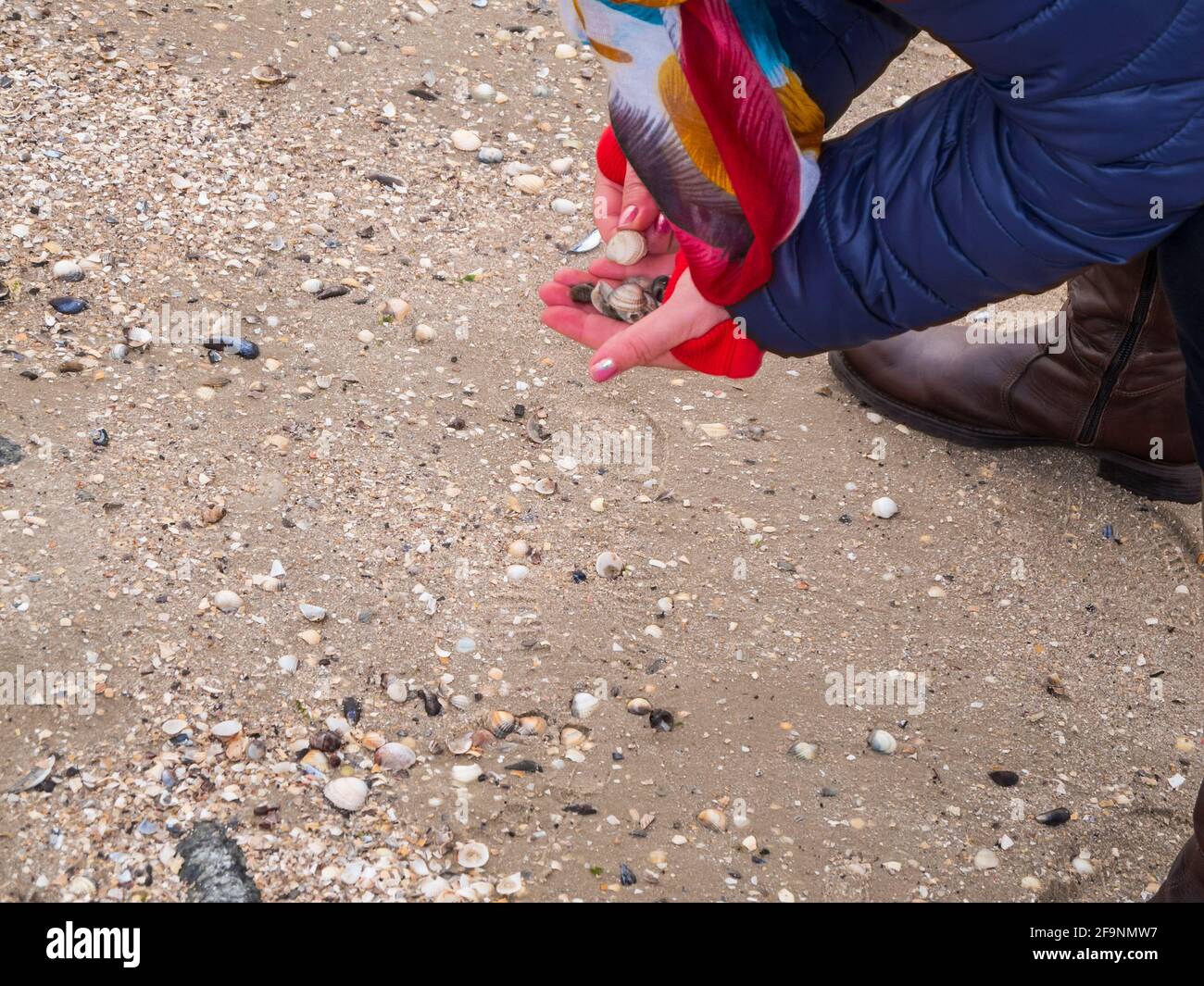 Hands and feet of an unrecognizable person on the North Sea beach