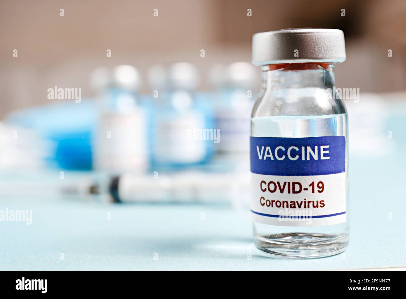 Macro shot of antiviral vaccine vial with syringe for immunization against covid-19 virus. Blurred out background with copy space for text. Close up, Stock Photo