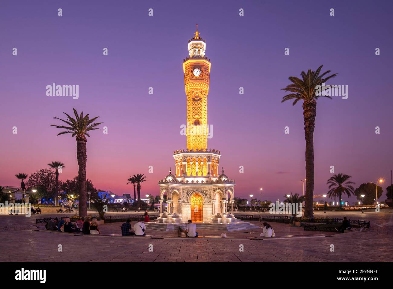 Konak Square street view with old clock tower (Saat Kulesi) at sunset. It was built in 1901 and accepted as the official symbol of Izmir City, Turkey Stock Photo
