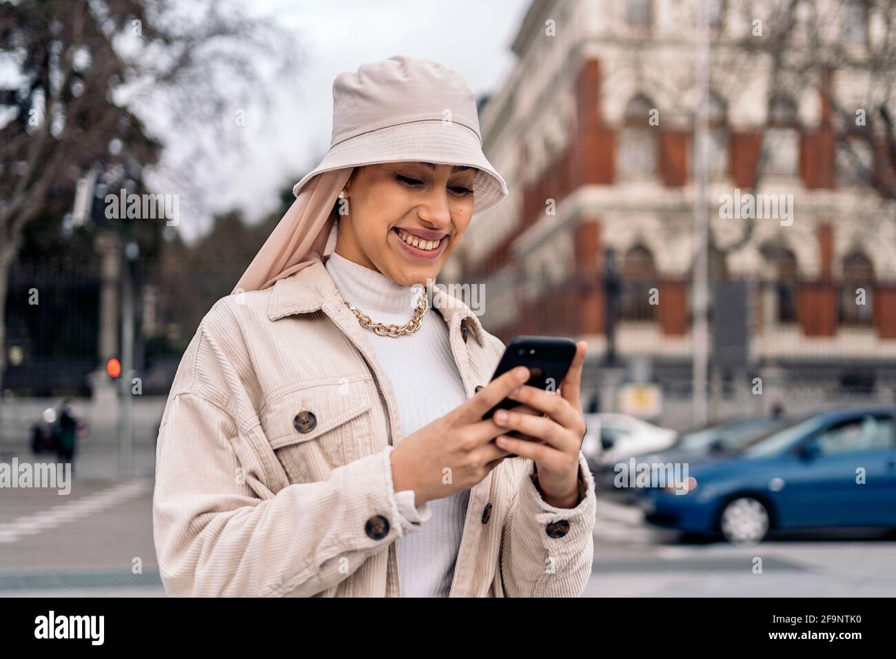 Beautiful muslim woman wearing head scarf using mobile phone in the ...