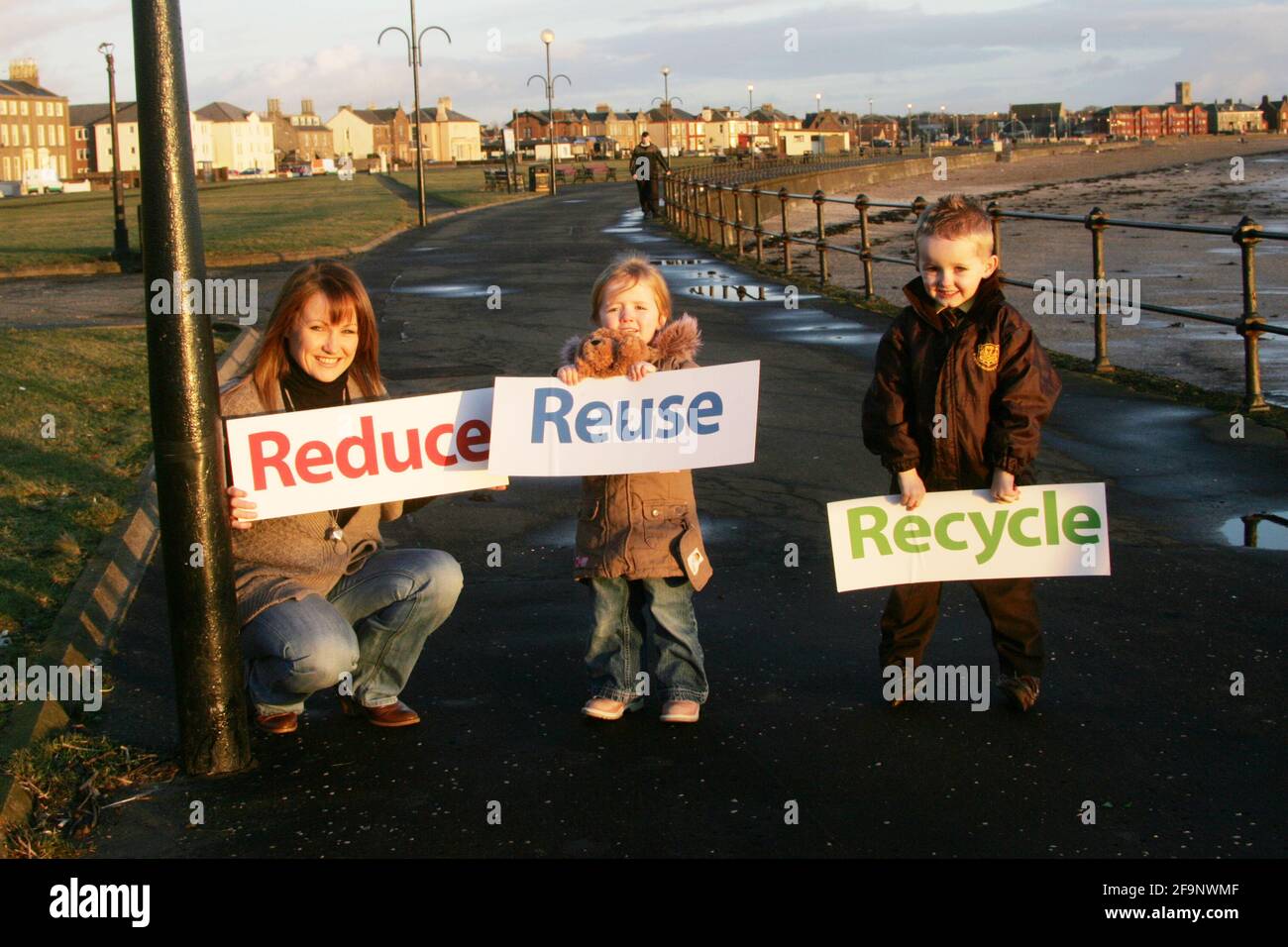Reduce Reuse Recycle. Mother with two children promoting campaign Stock ...