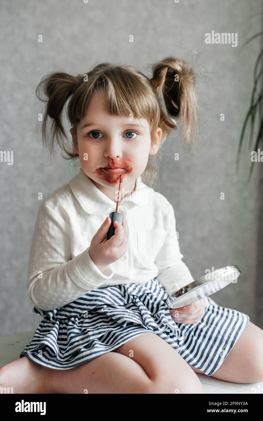 cute caucasian baby girl video blogger, phone on a tripod Stock Photo