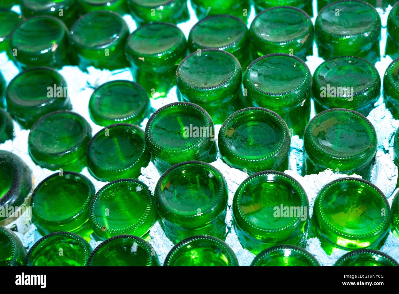 Green bottles in white wall abstract background Stock Photo - Alamy