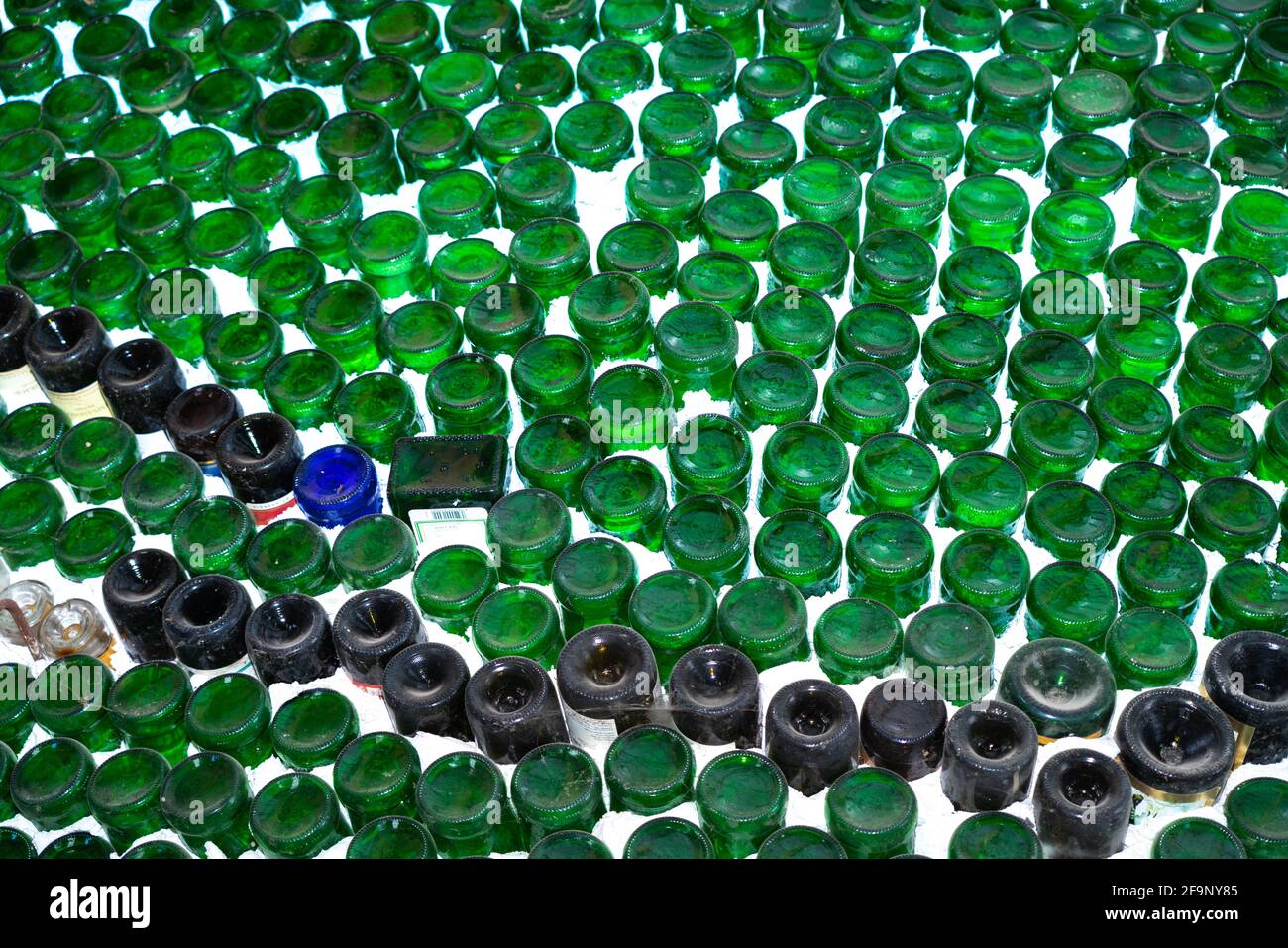 Green bottles in white wall abstract background Stock Photo - Alamy