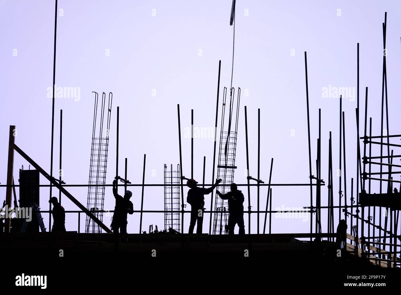 The group of workers working at a construction site. Stock Photo