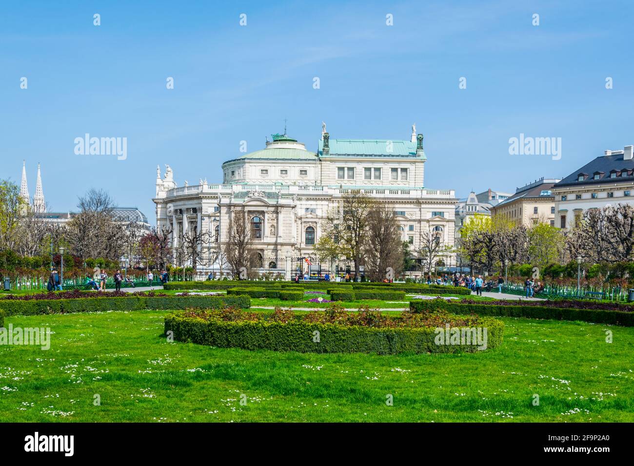Beautiful view of famous Volksgarten (People's Garden) public park with historic Burgtheater in the background in Vienna, Austria. Stock Photo