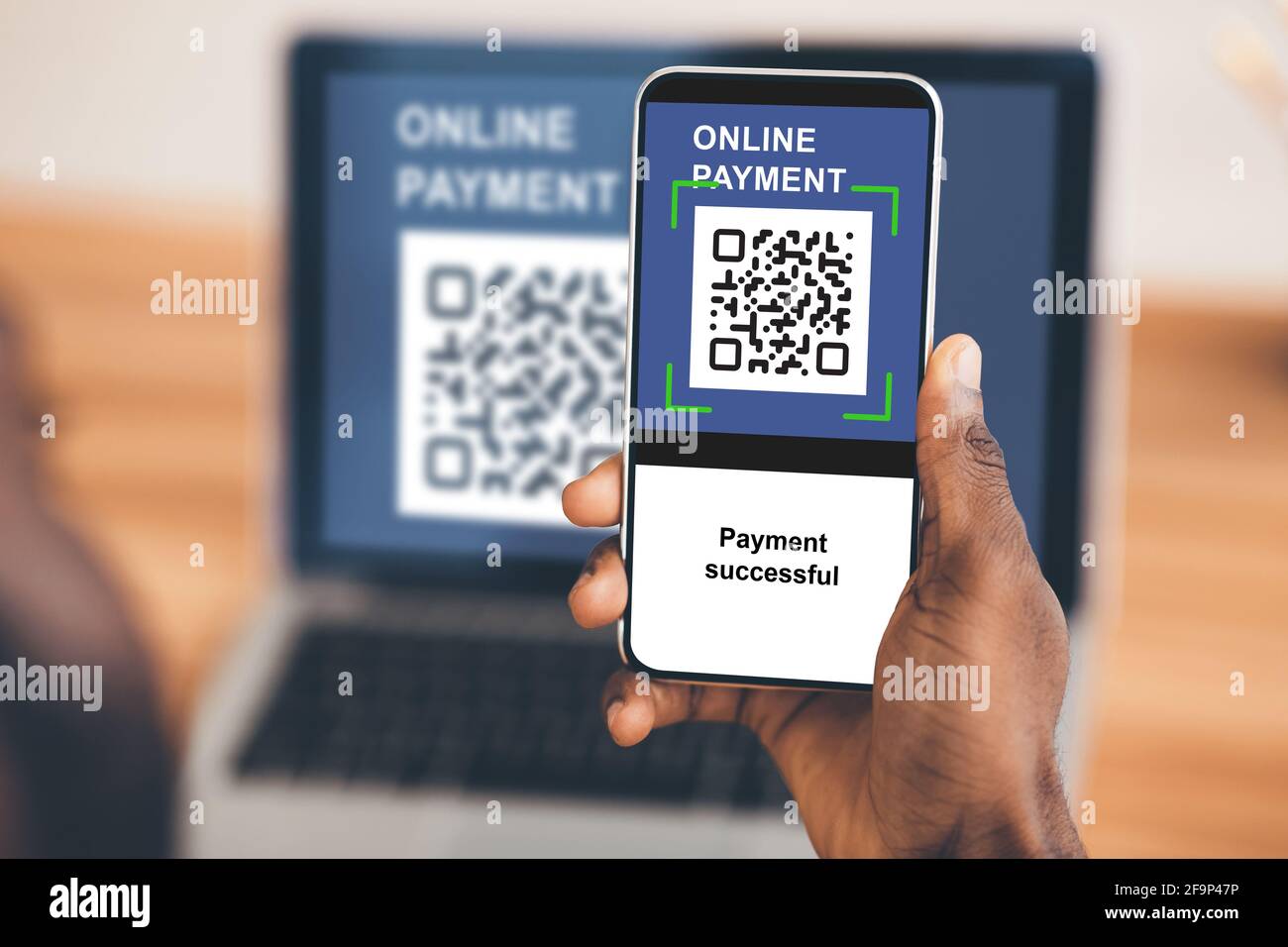 Black guy paying for goods and services online qr code Stock