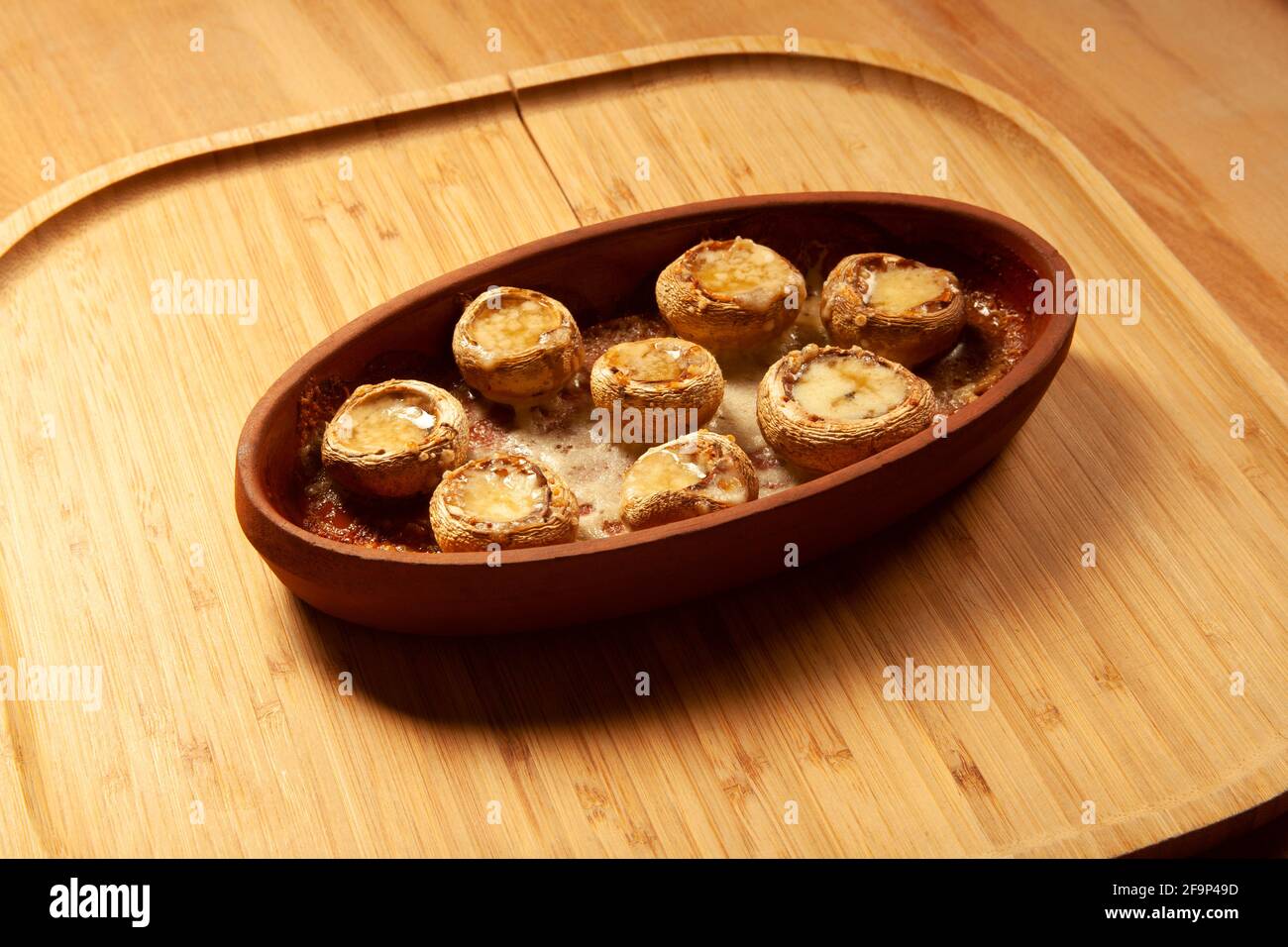 Baked white mushrooms in butter Stock Photo - Alamy