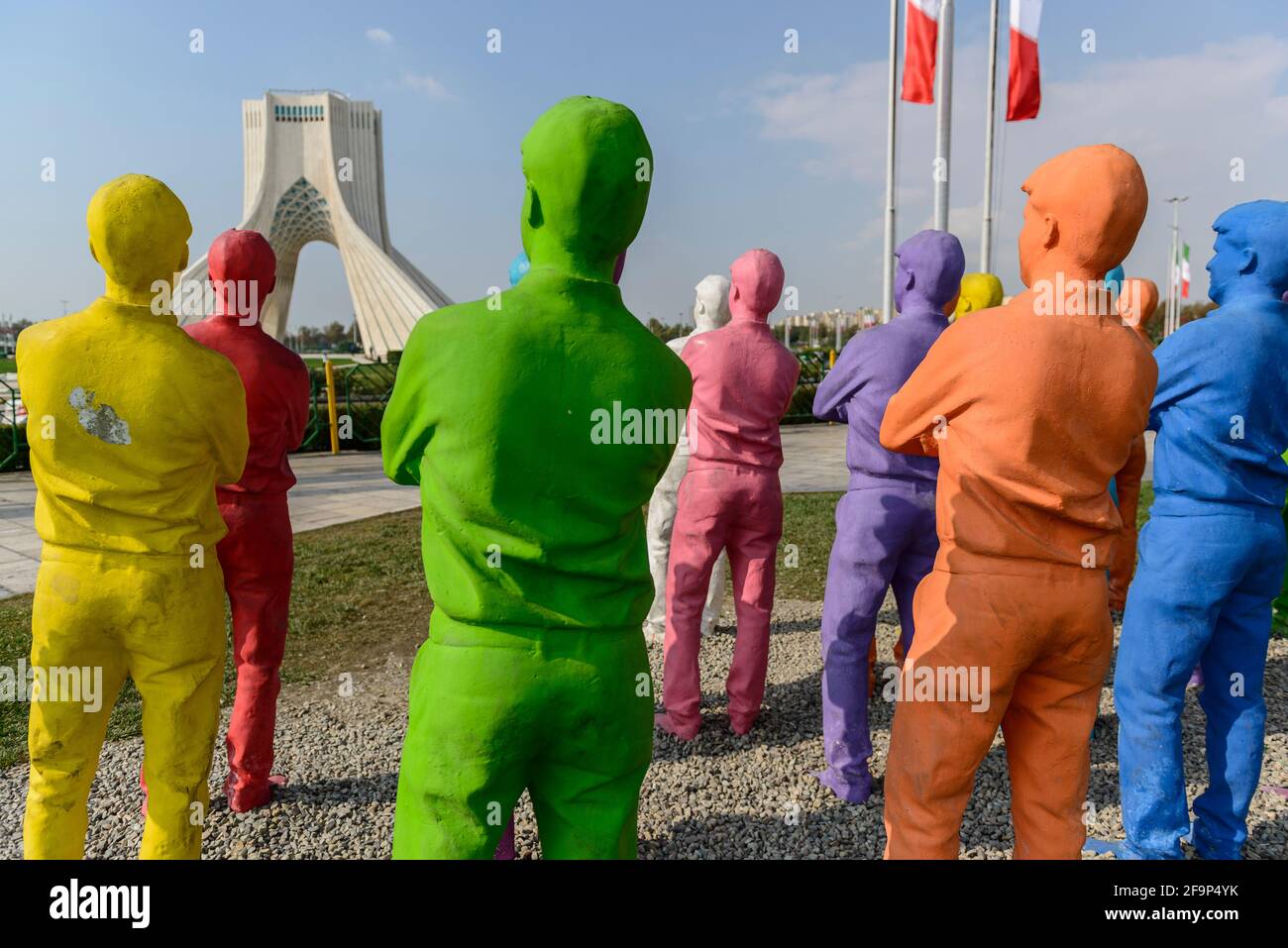 Group of painted copies of a male person looking at the Azadi Tower in Tehran, Iran. Stock Photo
