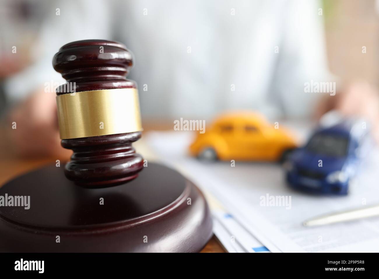 Judge holding hammer near toy cars closeup Stock Photo Alamy