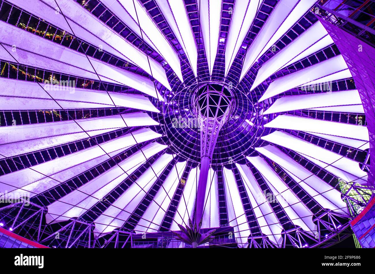 giant copula of sony center in berlin is made of white strips and is illuminated during night Stock Photo