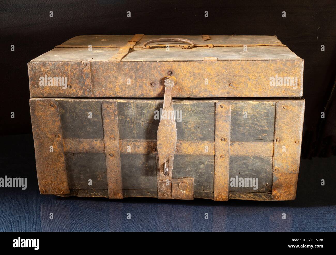 Old Box Colth An old chest on a black background close-up. Wooden box upholstered in ...