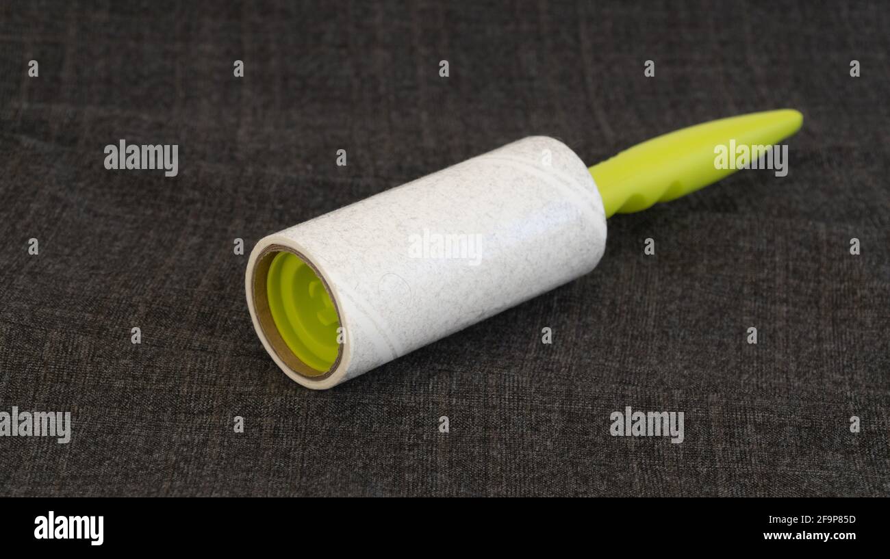 reusable sticky roller for cleaning clothes. Designed to remove dust, wool, lint from any type of fabric Stock Photo