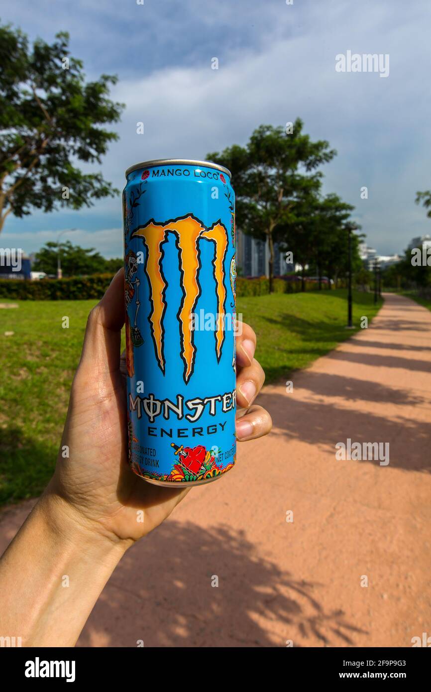 Fuel your day with a bottle of Monster Energy drink before hitting the outdoor trail. Stock Photo