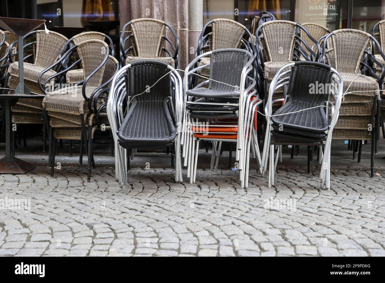 Leipzig, Germany. 15th Apr, 2021. Chairs and other outdoor furniture are stacked tightly at the edge of the pub mile 'Barfußgäßchen'. The otherwise overflowing with people is deserted during the corona-related closure of the gastronomy. Credit: Jan Woitas/dpa-Zentralbild/ZB/dpa/Alamy Live News Stock Photo