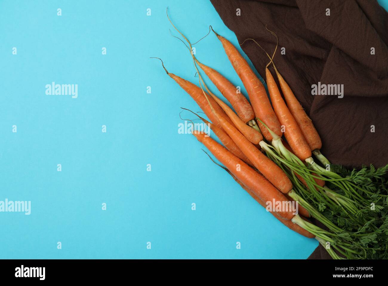 Kitchen towel with carrot on blue background Stock Photo