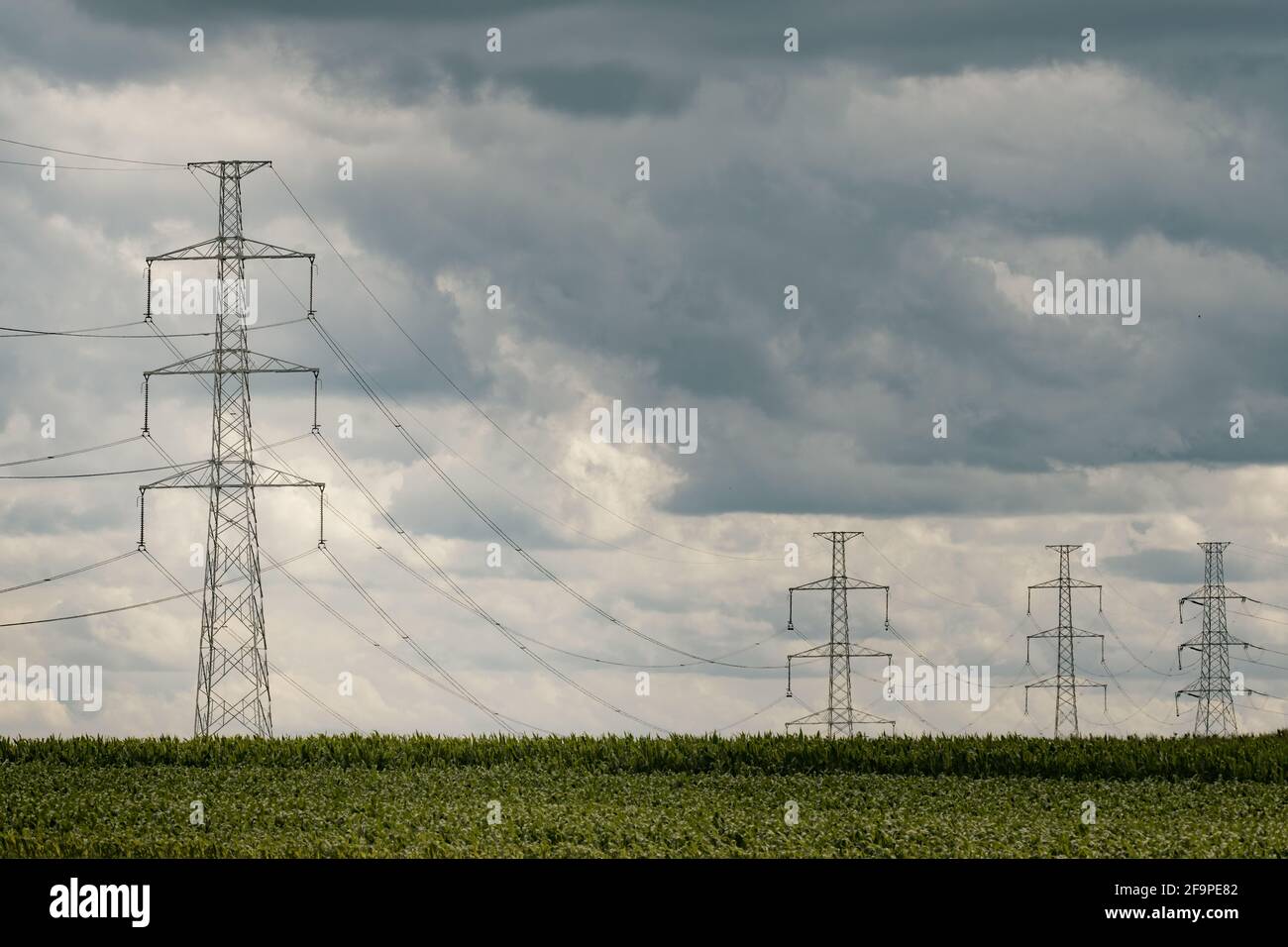 High voltage transmission towers under a cloudy sky Stock Photo - Alamy