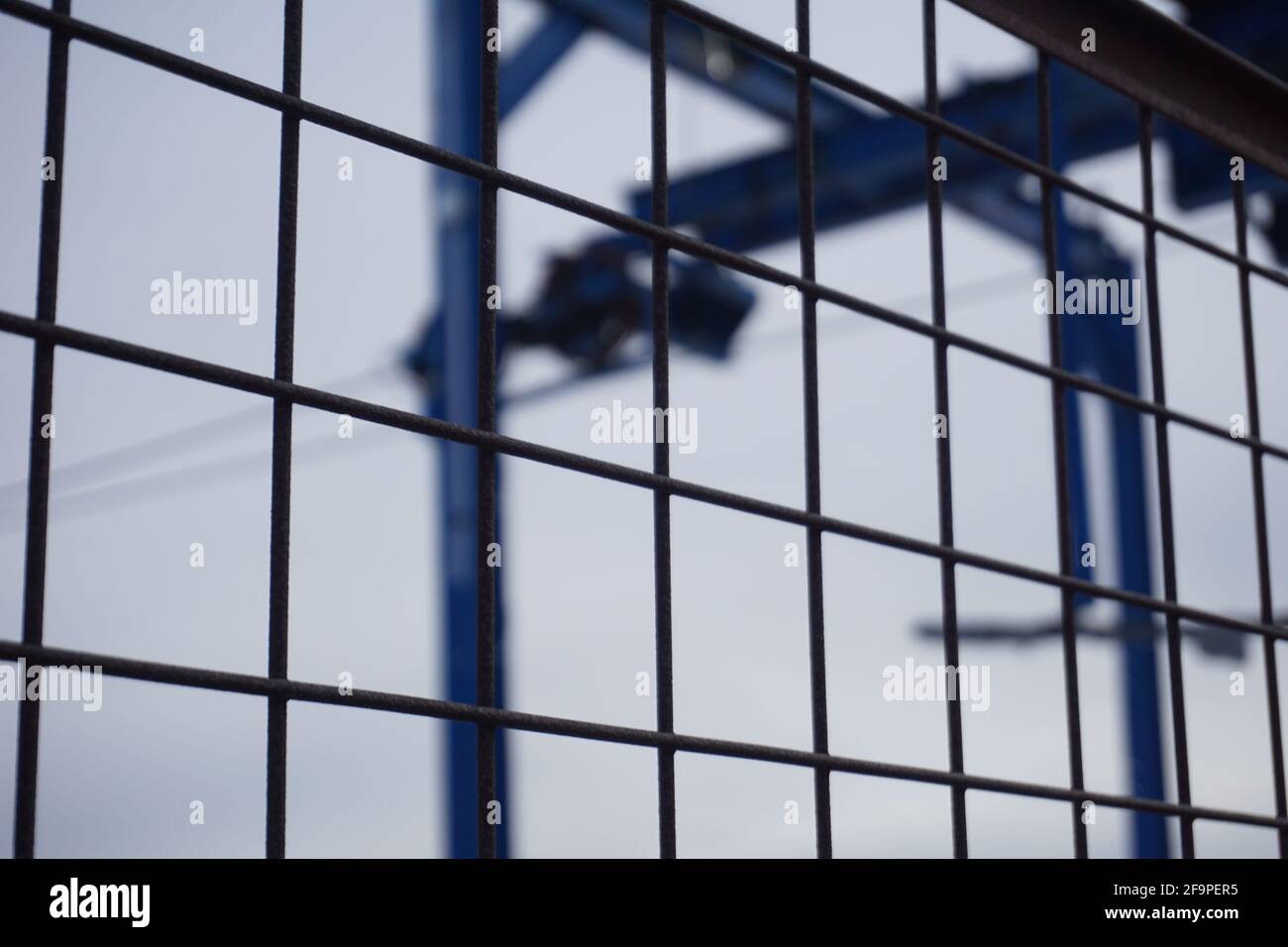 Selective focus of a metal grid fence Stock Photo - Alamy