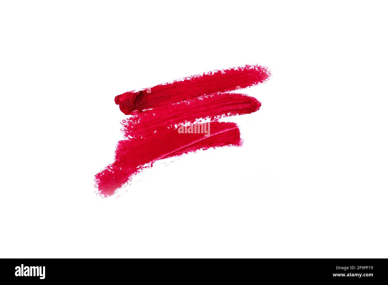 Lipstick smear smudge swatch isolated on white background. Cream makeup texture. Bright red color cosmetic product brush stroke swipe sample Stock Photo