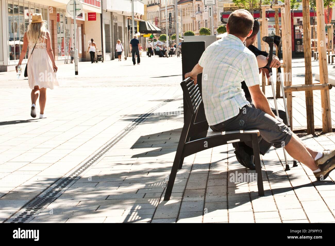 Woman walking past two young men hi-res stock photography and images ...
