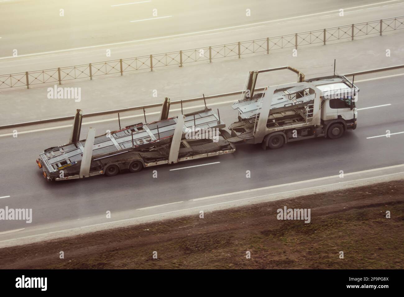 Truck with empty double-deck trailer for transporting new cars Stock Photo