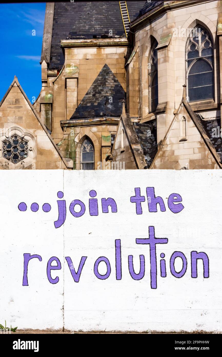 Words on a wall saying join the revolution. Stock Photo