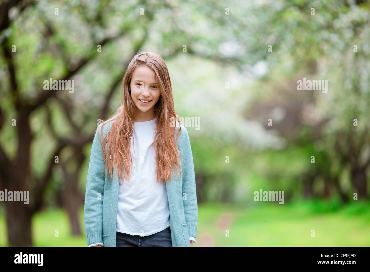 Little smiling girl playing in the park Stock Photo - Alamy