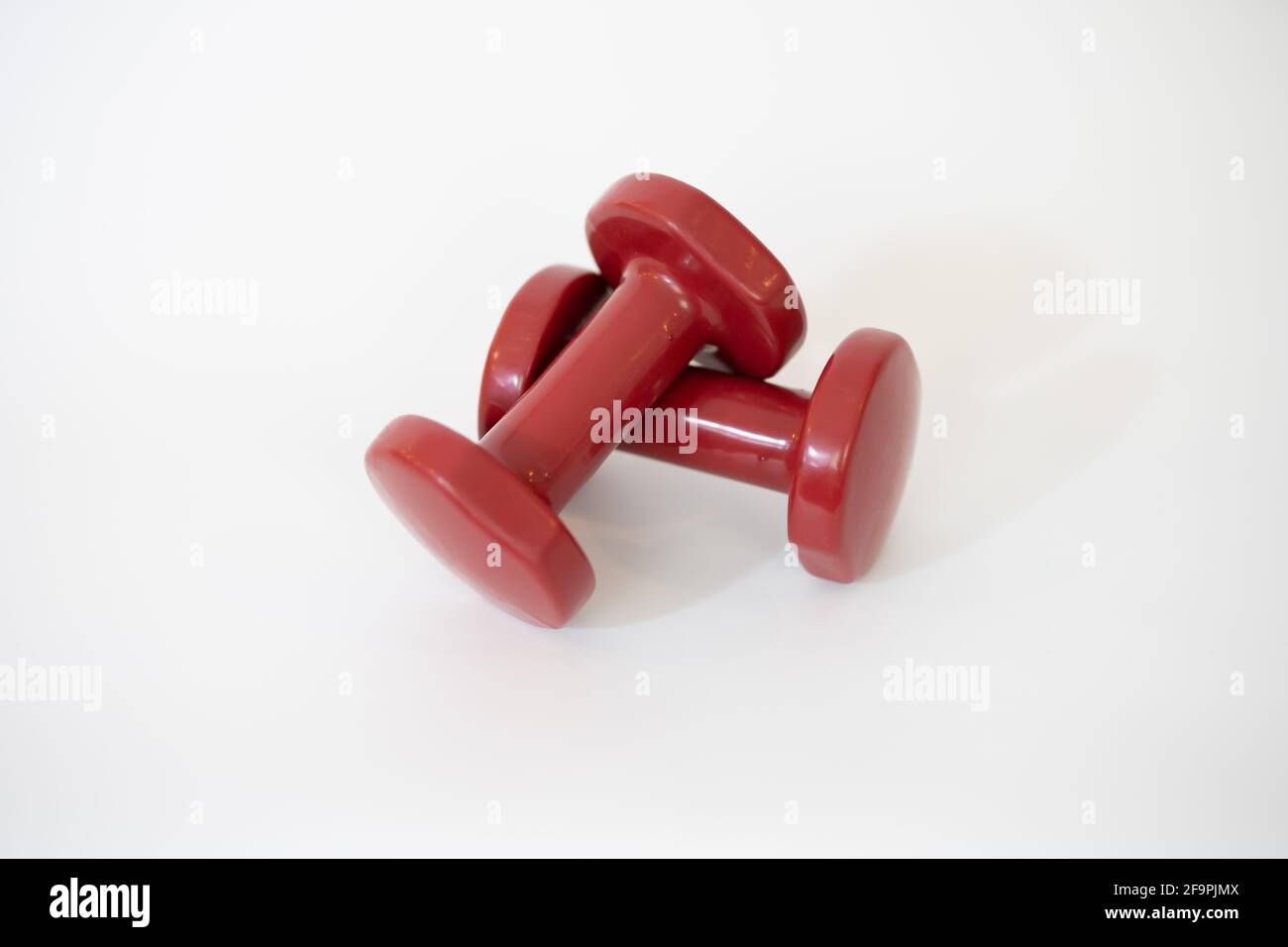 Pair of red dumbbells isolated on white background Stock Photo