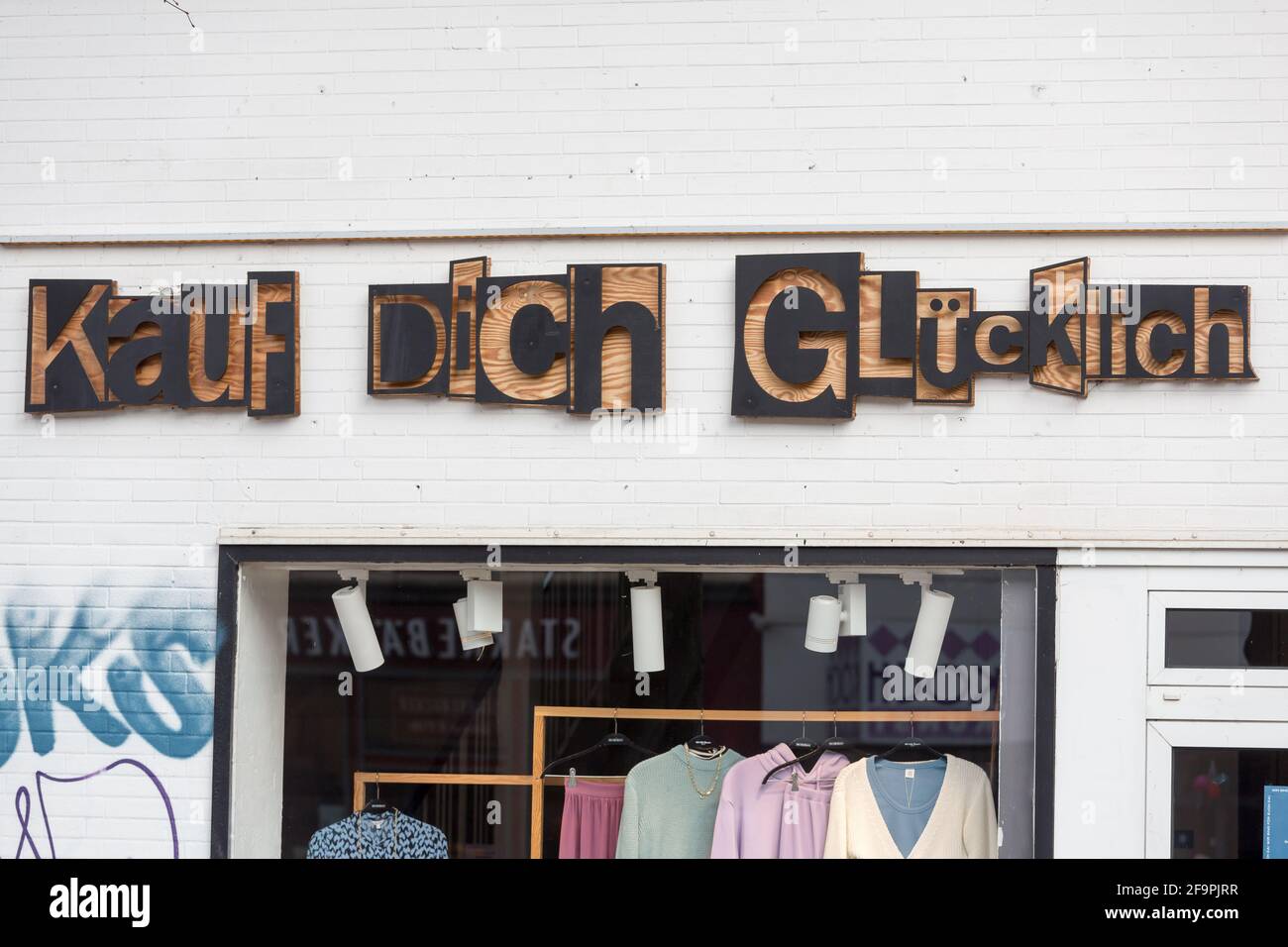 01.03.2021, Bremen, Bremen, Germany - Slogan KAUF DICH GLUECKLICH on the facade of a boutique. 00A210301D039CAROEX.JPG [MODEL RELEASE: NOT APPLICABLE, Stock Photo