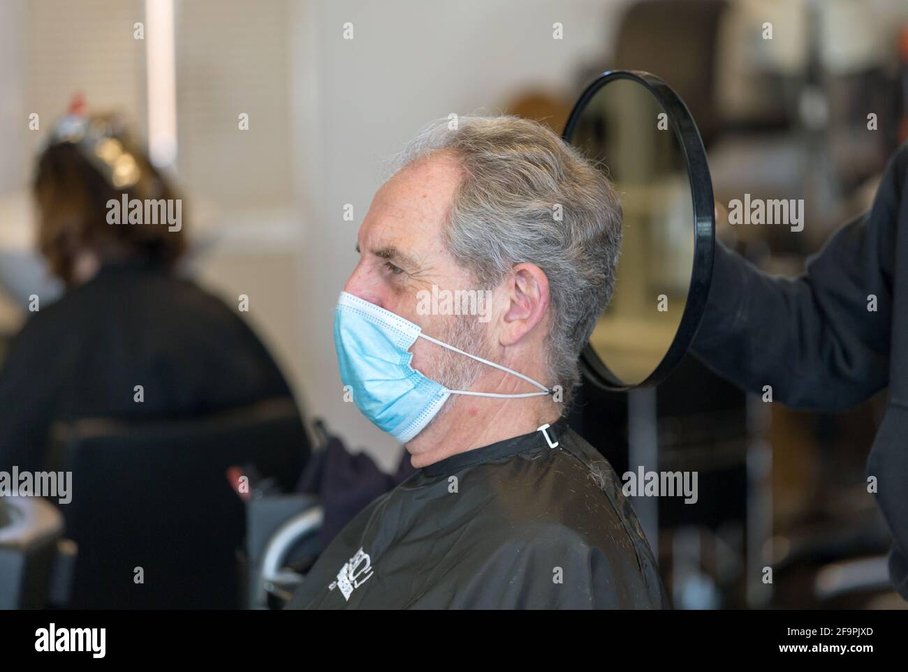 02.03.2021, Bremen, Bremen, Germany - Opening of the salon after the 2nd corona wave, client looking at the finished haircut in the mirror. 00A210302D Stock Photo