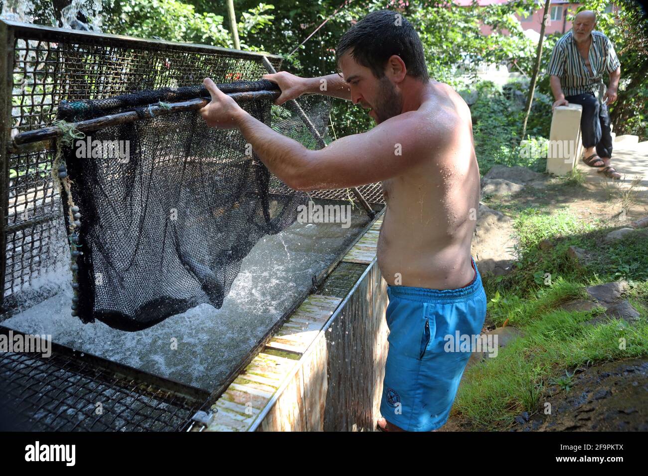 18.07.2018, Keda, Ajaria, Georgia - Man taking live fish out of a