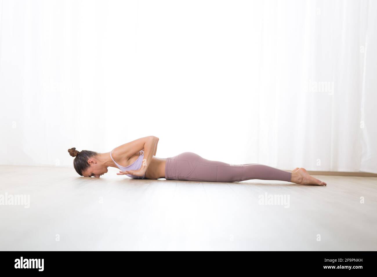 Portrait of gorgeous active sporty young woman practicing yoga in ...