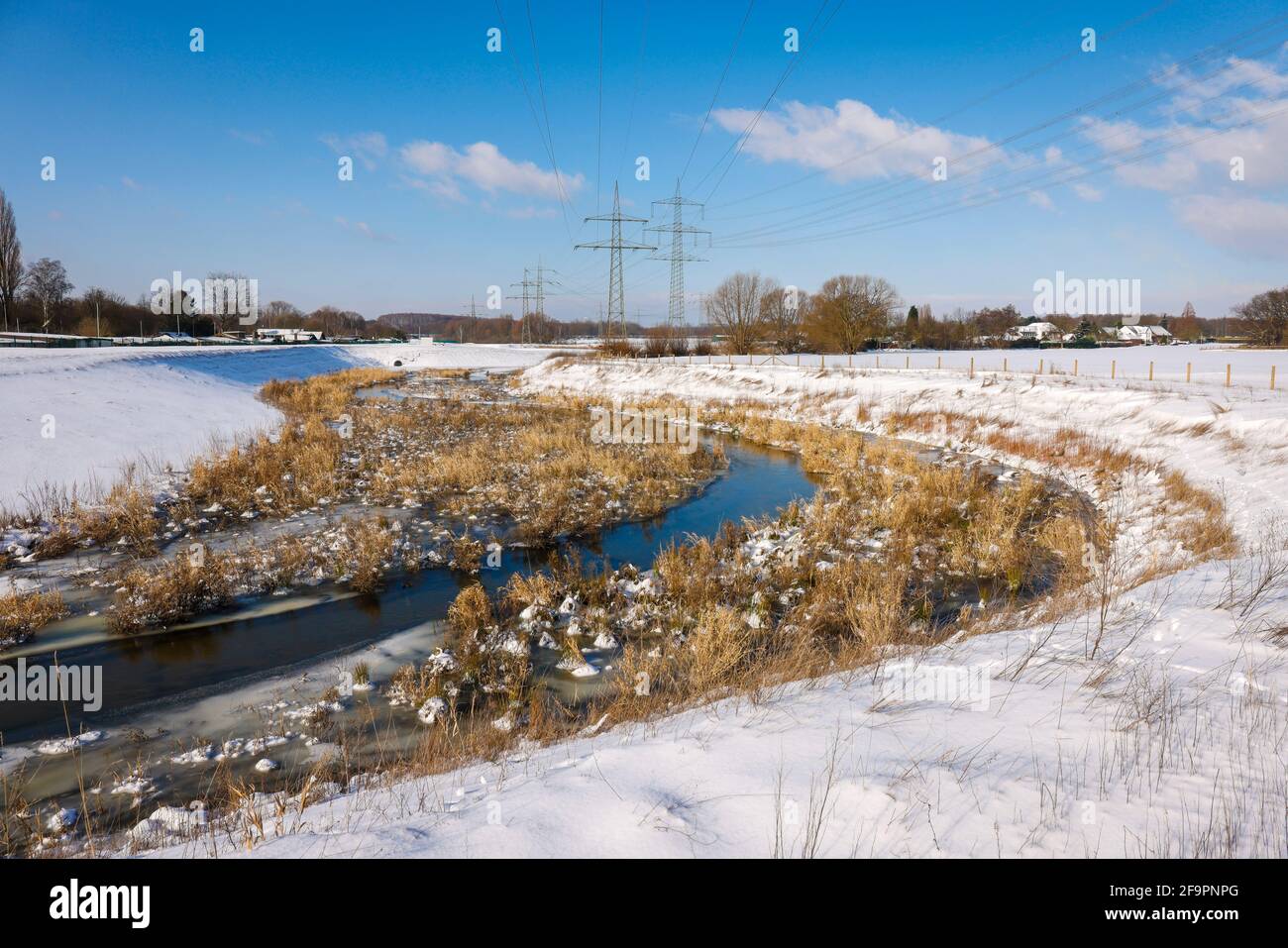 09.02.2021, Bottrop, North Rhine-Westphalia, Germany - Sunny winter landscape in the Ruhr area, ice and snow on the renaturalized Boye, the small rive Stock Photo