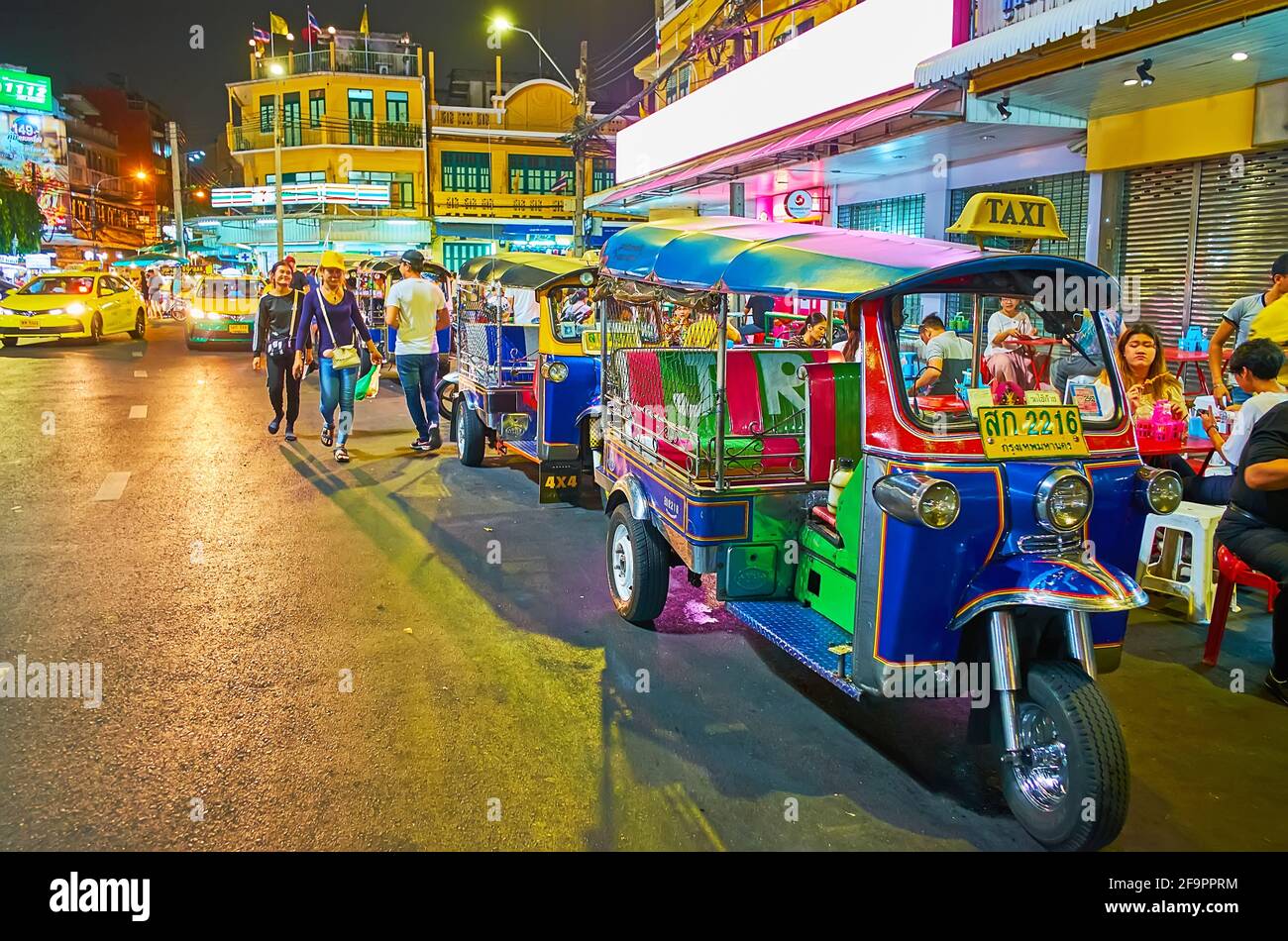 BANGKOK, THAILAND - MAY 11, 2019: The tuk tuk parking in crowded and noisy Khaosan Road with shops,  cafes and bars, on May 11 in Bangkok Stock Photo