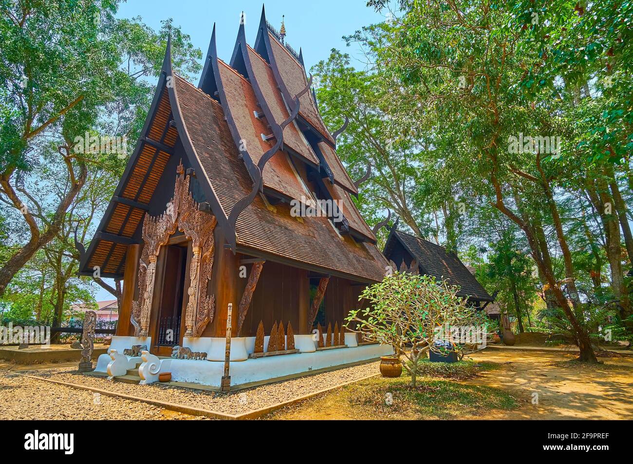 CHIANG RAI, THAILAND - MAY 11, 2019: The scenic  wooden Lanna style Sanctuary of Rama with tall gable roof, Black House (Baan Dam) Museum, on May 11 i Stock Photo