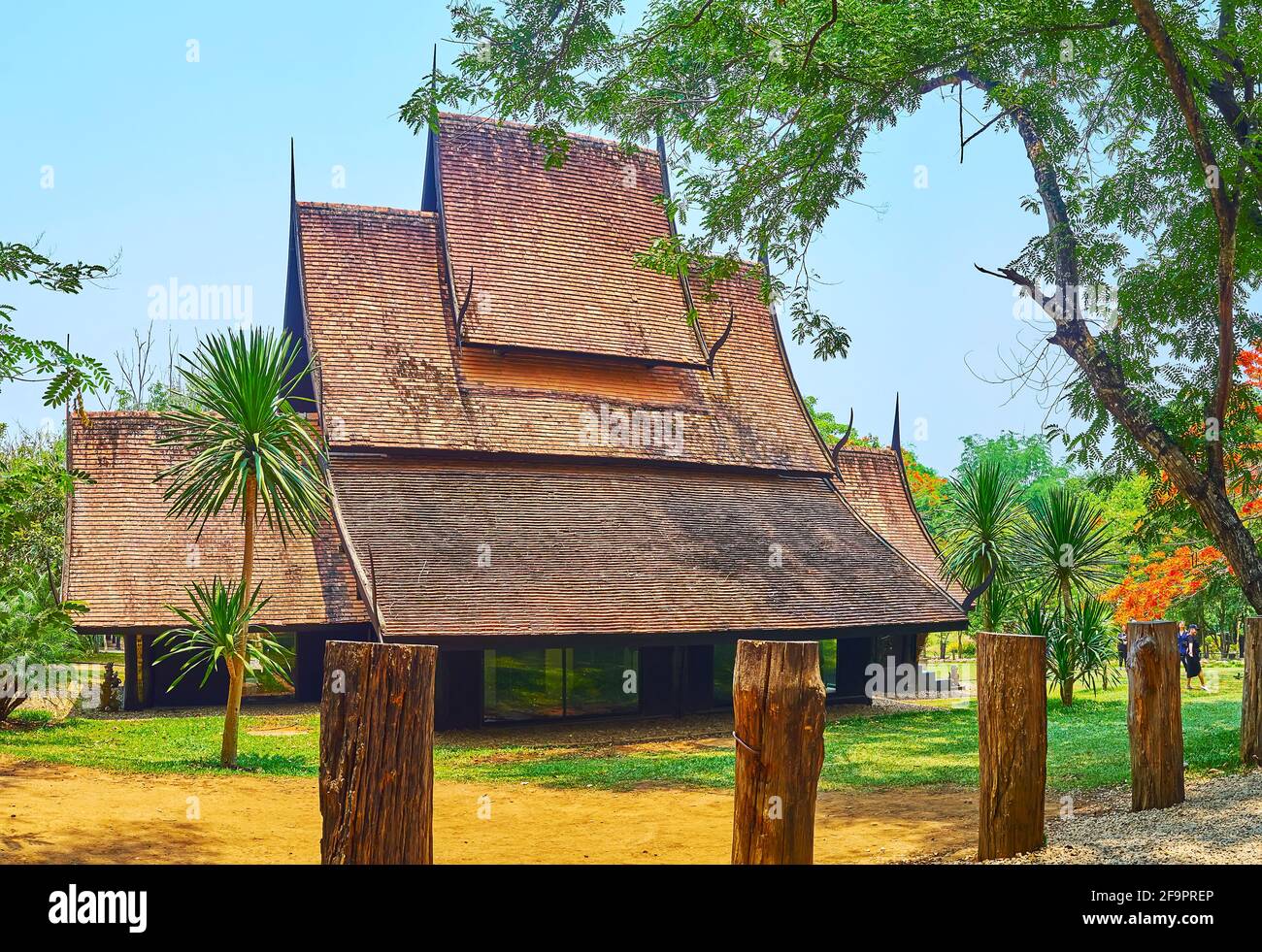 CHIANG RAI, THAILAND - MAY 11, 2019: The Cottage of Time with the scenic gable (pyathat) roof on grounds of Black House (Baan Dam) Museum, on May 11 i Stock Photo