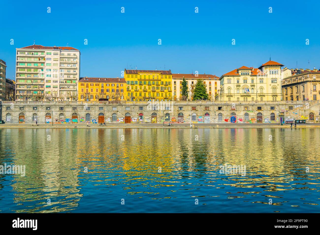 historical buildings stretched along riverside of po river in the ...