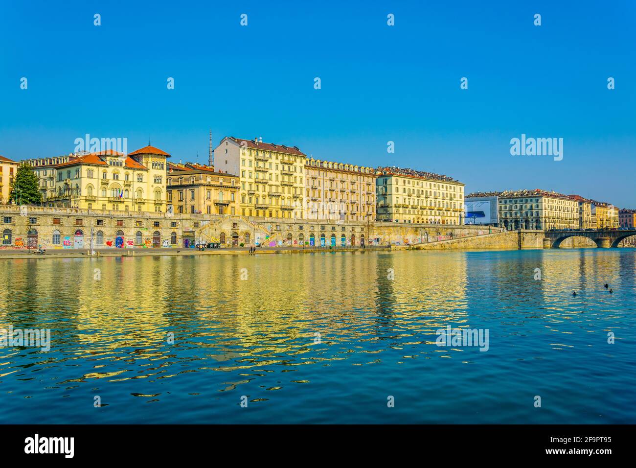 historical buildings stretched along riverside of po river in the ...