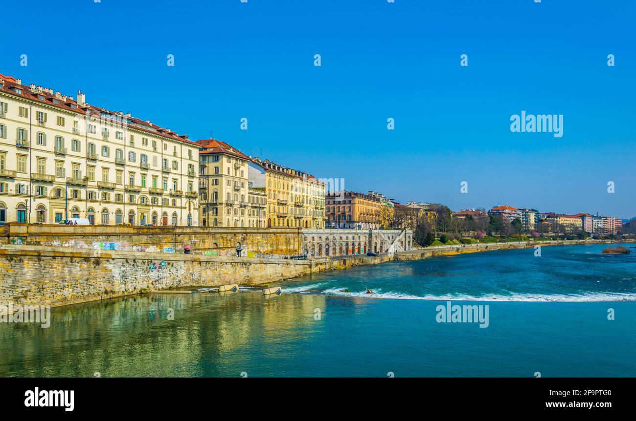 historical buildings stretched along riverside of po river in the ...