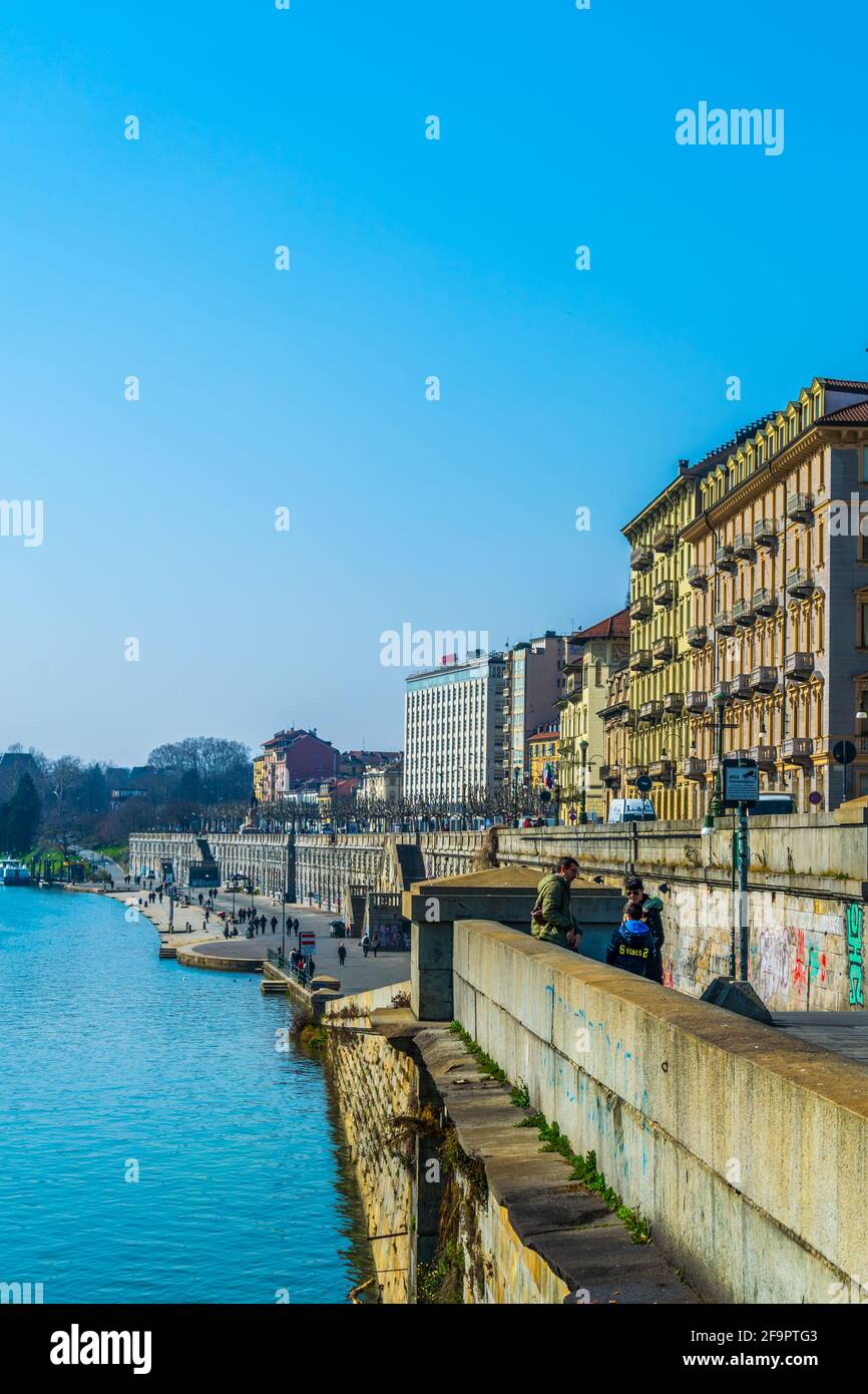 historical buildings stretched along riverside of po river in the ...