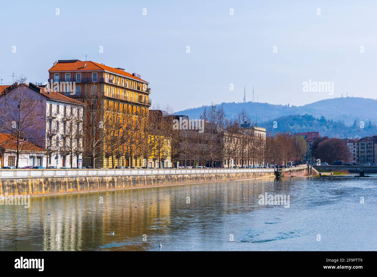 historical buildings stretched along riverside of dora riparia river in ...