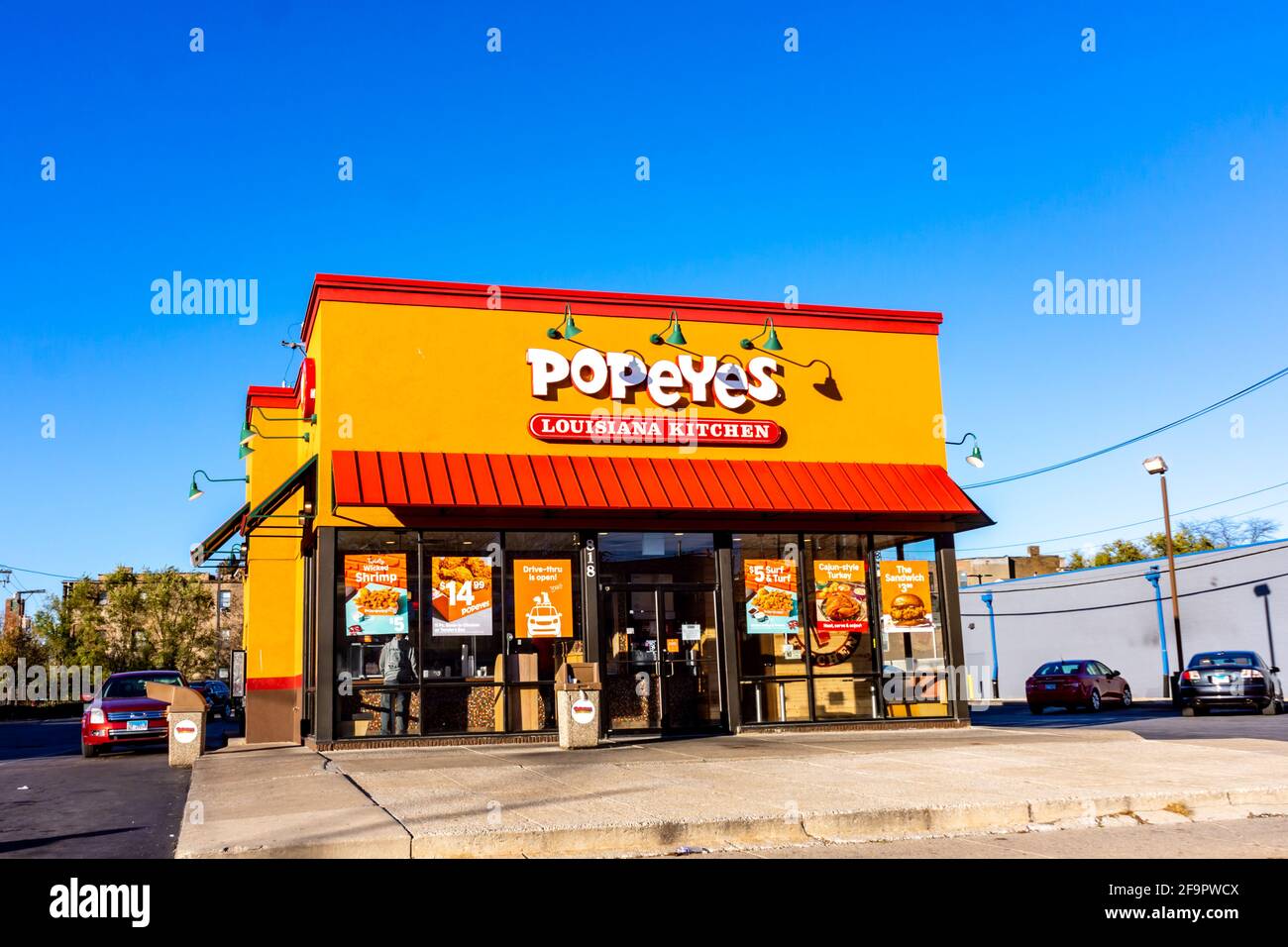 The exterior facade of a Popeye's Louisiana Kitchen fastfood chicken