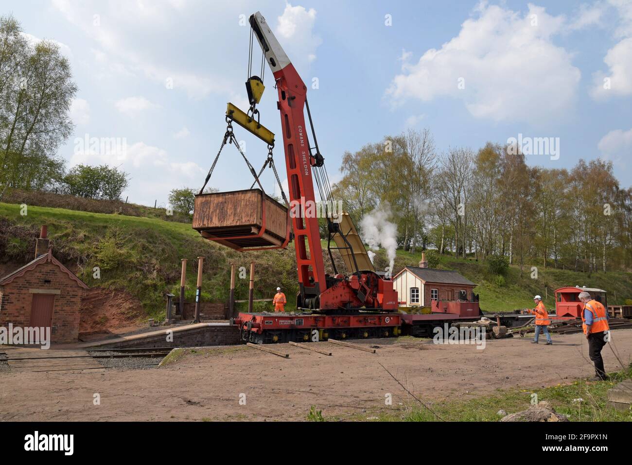Eardington, Shropshire, UK. 20th April 2021. Volunteers at the Severn Valley Railway, one of the UK's premier heritage railways using a Cowans Sheldon 30-ton steam crane built in 1960. The crane is lifting a water tank off its columns for restoration and reuse on the railway. GP Essex/Alamy Live News - Stock Image