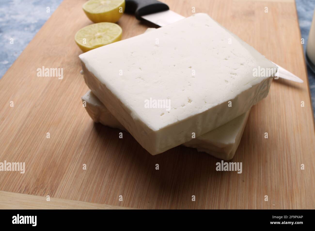 paneer making recipe ingredients, milk and lemon with fresh cottage cheese. Stock Photo