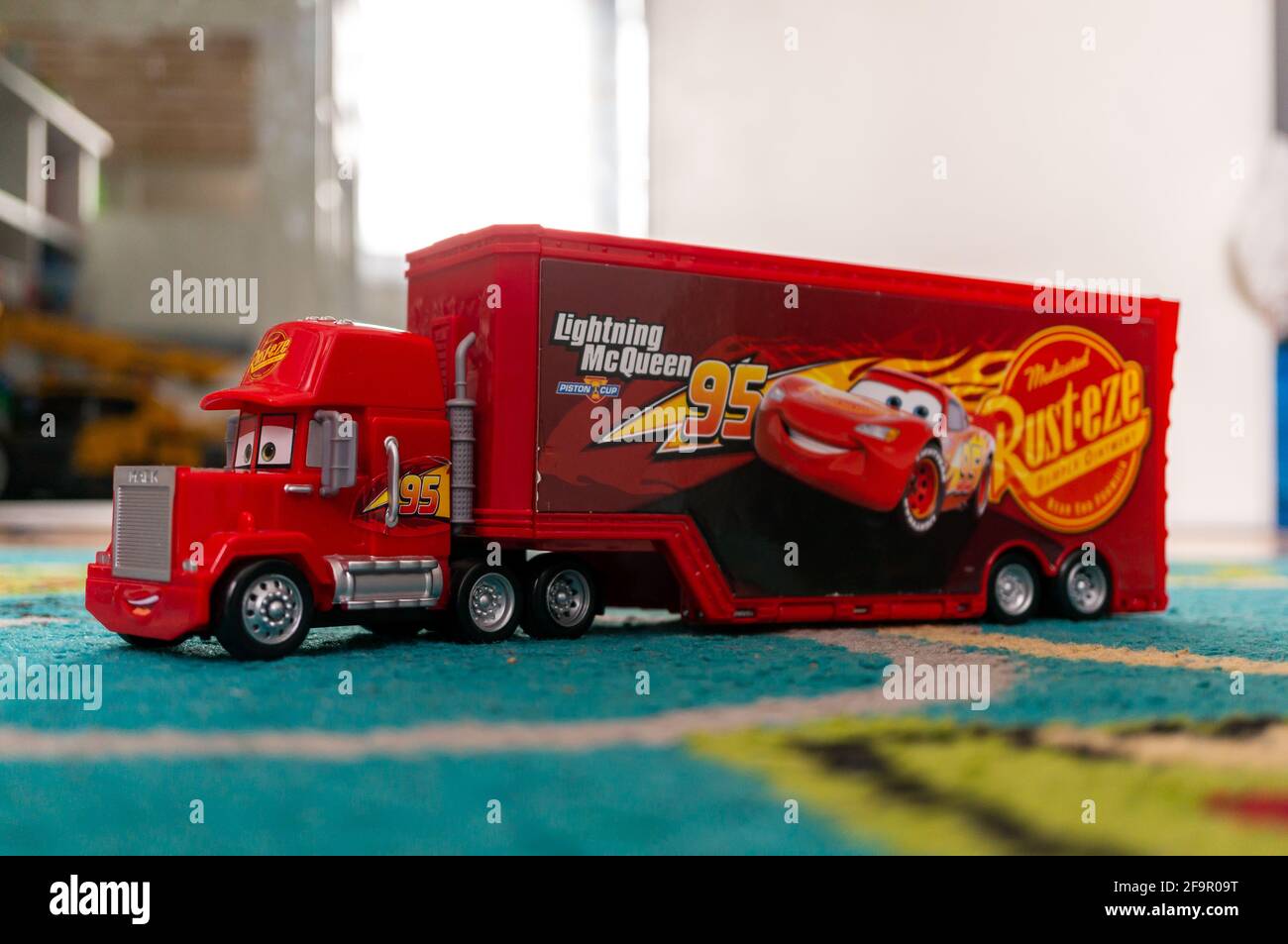 POZNA, POLAND - Apr 06, 2021: Red toy model Mack truck with trailer of the  Disney Pixar Cars movie on a carpet floor in a child room Stock Photo -  Alamy