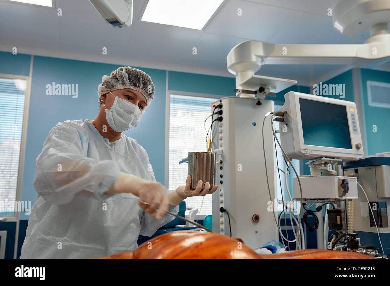 Surgeons or doctor hands with protective glove hold sponge holding a sterilzed gauze with